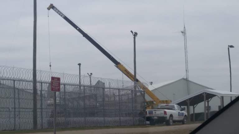 Image of commercial chain link fencing, barbed wire, and security lighting at Gus Harrison Correctional Facility