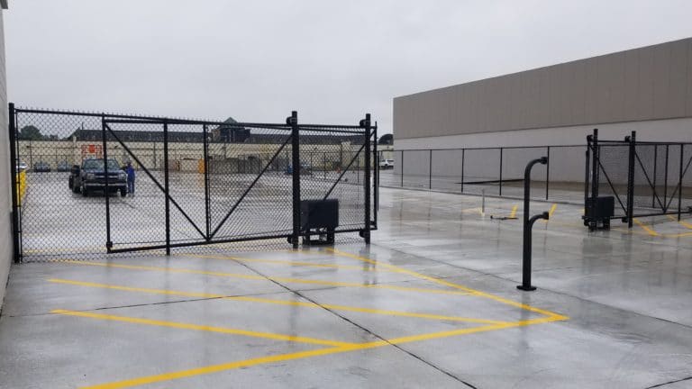 Image of new commercial chain link fencing, sliding gate, and electric gate operator (access control system) at Van der Graaf