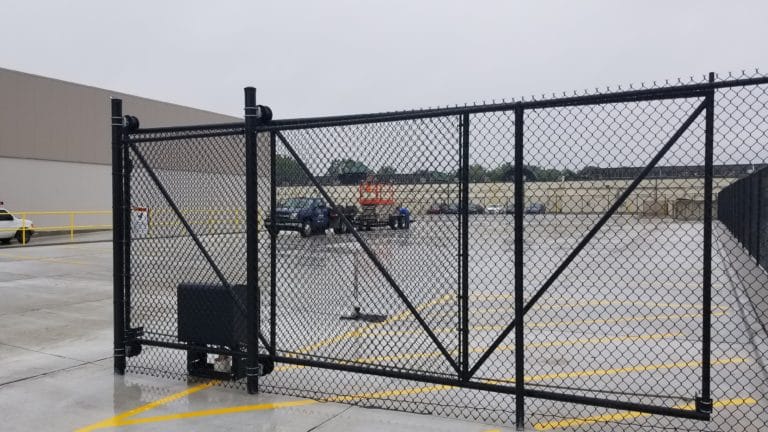 Image of new commercial chain link fencing, sliding gate, and electric gate operator (access control system) at Van der Graaf