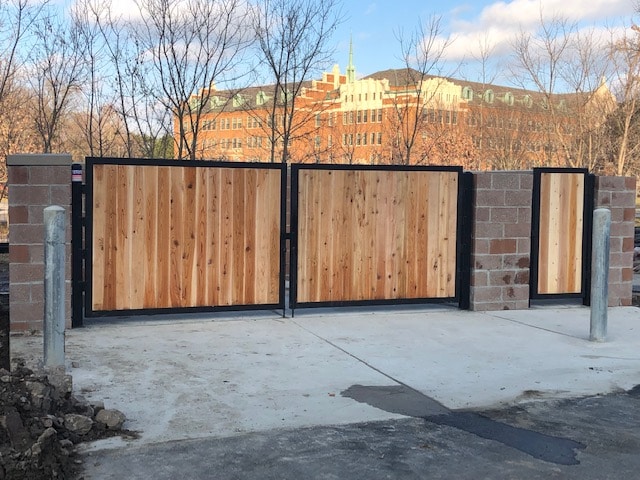 Image of commercial wood and steel dumpster gates at Norman Towers Senior Apartments