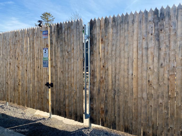 Image of commercial wood stockade patio fencing and swing gate at Cadieux Cafe