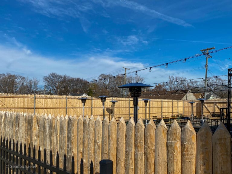 Image of commercial wood stockade patio fencing at Cadieux Cafe