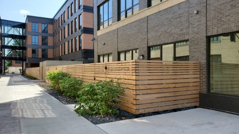 Image of commercial wood privacy fencing and swing gates at Elton Park Corktown in Metro Detroit, Michigan