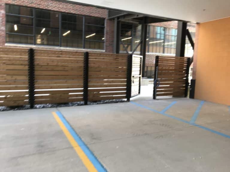 Image of commercial wood privacy fencing and swing gates at Elton Park Corktown in Metro Detroit, Michigan