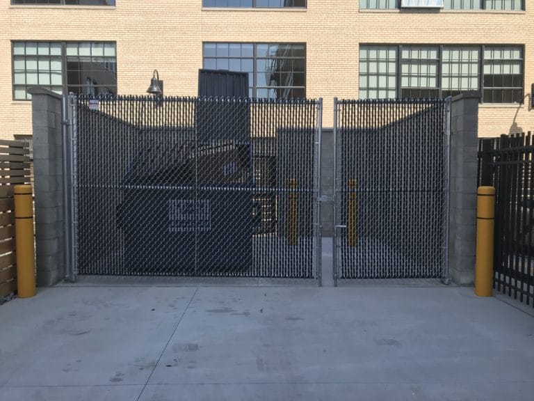 Image of commercial chain link fencing and swing dumpster gates at Elton Park Corktown in Metro Detroit, Michigan