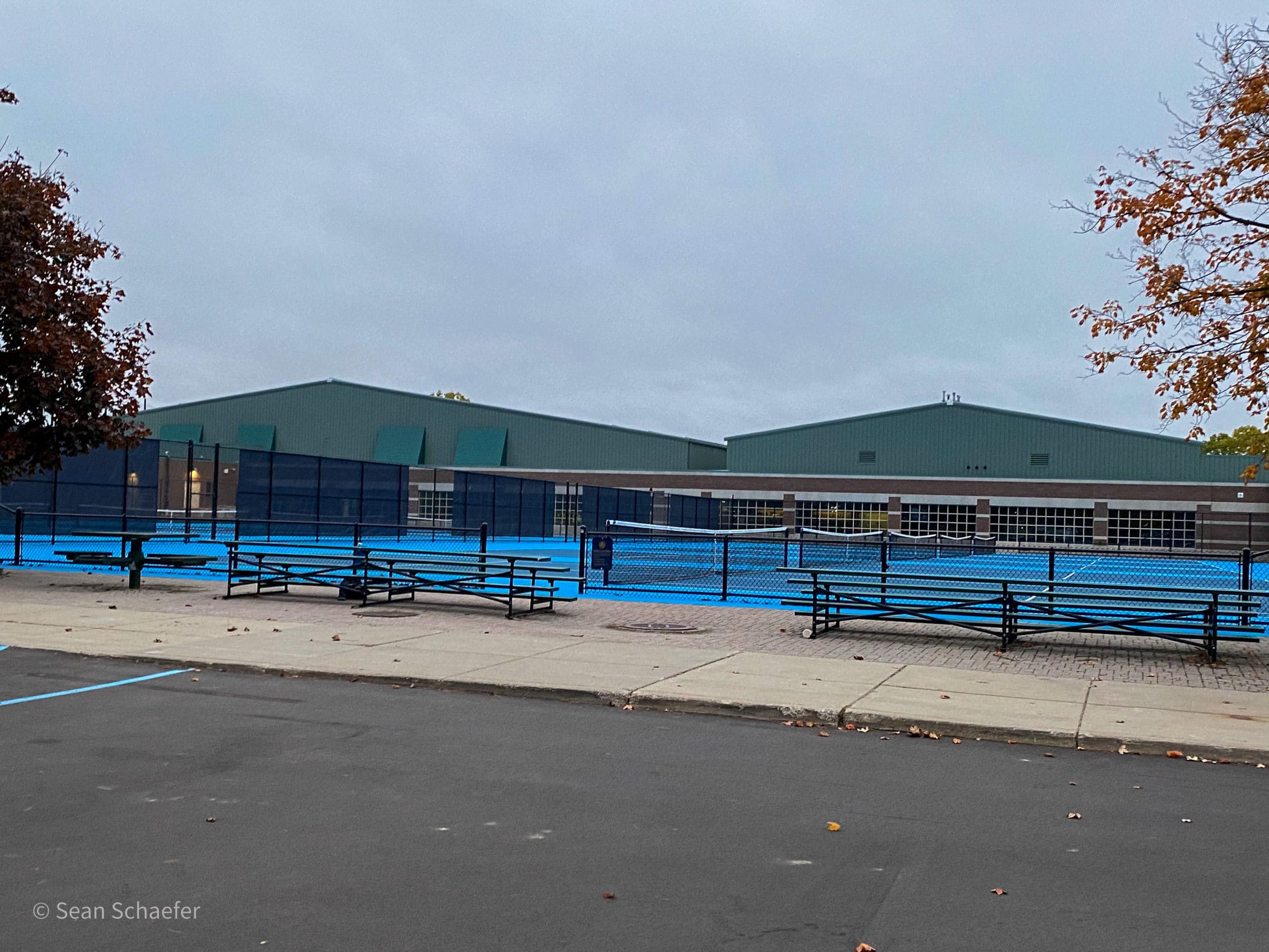 Image of commercial tennis courts with chain link fencing and posts at Detroit Country Day School
