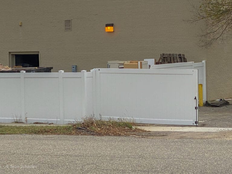 Image of PVC / vinyl commercial dumpster enclosure and gates at Habitat for Humanity ReStore
