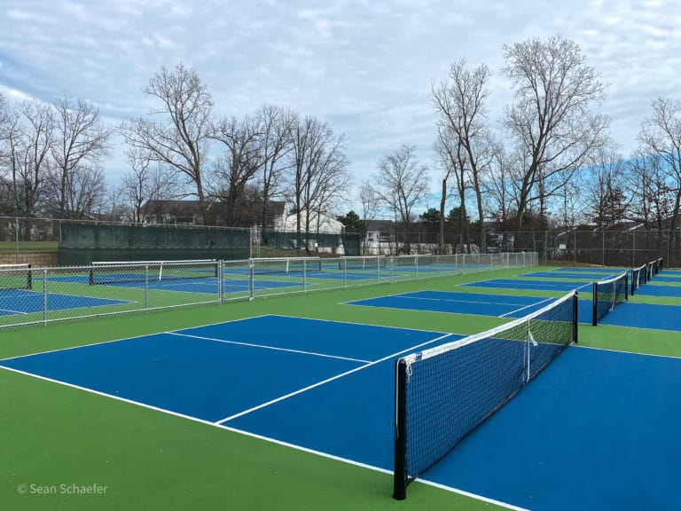 Image of new pickle ball courts, commercial chain link fencing, nets, and posts in Metro Detroit, Michigan
