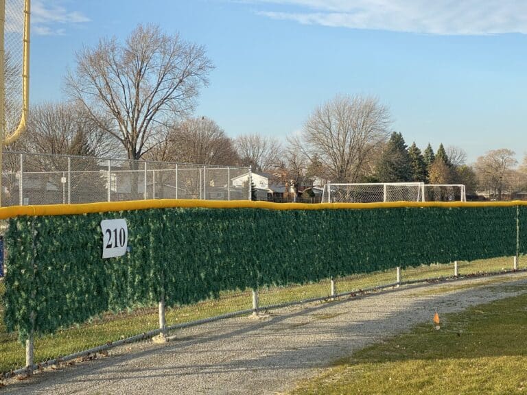 Image of commercial chain link baseball diamond fencing, PVC top cap, and Christmas tree slats at Cousino High School